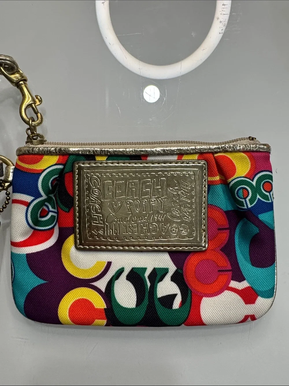 Coach Poppy Multicolor signature wristlet with gold accents and 
